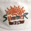 A white bucket hat featuring colourful embroidery of a sun and the words "Summer Fun". It has a logo as well.