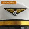 A white cap with a woven patch featuring yellow wings and a star, accented with a gold band.