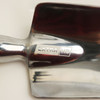 A shiny metal garden spade with a reflective surface and a sturdy handle. It features a logo on the blade.