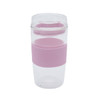 A reusable coffee cup in clear and light pink with a silicone sleeve and a lid featuring a logo.