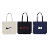 Three tote bags in various colours: a beige bag with a logo, a black bag with a logo, and a navy bag with a logo.