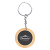 A round bamboo keyring with a silver metal chain and a circular black centre featuring a logo.