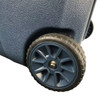 A dark blue cooler box with textured surface and a sturdy wheel for easy transport.