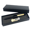 A black pen and silver clip in an elegant gift box with a textured design. The box is open to reveal its contents.