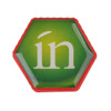 A hexagonal flash drive in green and red, featuring the word "in" in white on the surface.