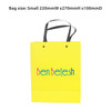 A small yellow knitted handle bag with lamination, featuring a logo and black handles. Dimensions are 220x270x100mm.