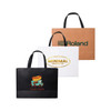 Three paper bags with flat handles: one brown, one white with a logo, and one black featuring a food truck graphic.