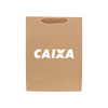 A large brown paper bag with a fabric flat handle and a logo on the front.
