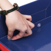 A hand fastens a connector inside a red and blue three-tier counter display unit. The unit features a sleek design.