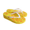 A pair of yellow talking footprint thongs with a patterned top and white straps, featuring a logo.