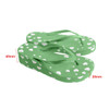 Green flip-flops with white heart patterns, featuring a textured surface and a slight rise in height.