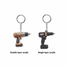 A custom shape acrylic keyring featuring a yellow and black drill design, with a silver keyring attachment.