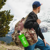 A drink bottle in a vibrant green colour attached to a backpack, set against a mountainous backdrop.