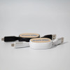 A white and a black retractable charging cable, each with a logo on the circular casing.