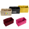 Five felt bag organisers in beige, black, yellow, burgundy, and pink, each with various pockets and a logo.