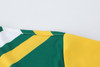 A close-up of a long-sleeved shirt featuring green and yellow polyester micro mesh with a logo.