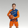 A model wearing a blue and orange long-sleeve polo shirt holds a basketball. The polo features a logo.