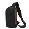 A black and brown anti-theft sling bag with a padded strap and multiple zippered compartments.