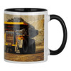 A ceramic mug with a black handle features a large yellow and black mining truck design.