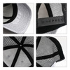A grey mesh back trucker hat featuring a black visor and adjustable strap, showcasing interior details and stitching.