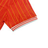 A vibrant red T-shirt with yellow stripes and white striped cuffs, featuring a logo.