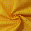 A yellow mesh fabric with small perforations, ideal for sports uniforms and jerseys.