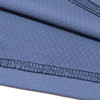 A close-up of a soft, blue polyester spandex fabric with visible stitching details.