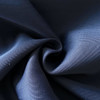 A close-up of navy fabric displaying a soft, smooth texture with a subtle sheen.