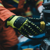 Heavy duty safety work gloves in black and bright yellow, featuring a wrist lock and palm guard, worn on a hand.