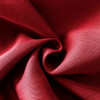 A close-up view of red polyester spandex fabric, showcasing its smooth texture and soft drape.