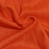 Bright orange fabric with a textured pattern, suitable for breathable sports shorts. Includes a logo or branding.