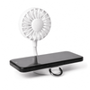 A white rechargeable fan attached to a phone stand, displaying a black smartphone. The fan features a flexible neck.