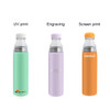 A drink bottle collection featuring a mint green, lavender, and orange stainless steel vacuum bottle with various finishes and a logo.
