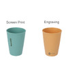 Two wheat straw toothbrush cups. One is teal with vertical ribbing, and the other is tan, also ribbed, featuring branding.