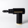 A black massage gun with gold accents, featuring a pointed attachment and a sleek, modern design.
