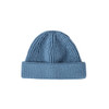 A round beanie in a soft blue shade with a ribbed texture and a folded cuff. It features a logo on the side.