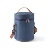 A cylindrical lunch bag in navy blue with a zip closure and adjustable shoulder strap. Features a carrying handle.