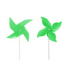 A vibrant green four-leaf pinwheel with a white stick, featuring two playful pinwheel designs.