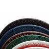 A stack of PU coasters in various colours including black, blue, green, brown, and white, with detailed stitching.