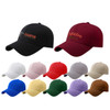 A collection of cotton baseball caps in various colours, featuring black and burgundy options with logos.