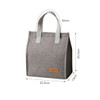 A grey minimalist lunch bag with white straps, featuring a logo and measuring 34cm in height and 22.5cm in width.