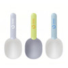 Three 2 in 1 pet food scoops in pale grey, lime green, and light blue, each with a logo on the handle.