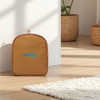 A foldable travel duffle bag in a warm brown colour, featuring a logo, resting on a wooden floor.