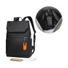 A black laptop backpack features a front pocket with an orange tag and a section for a charging cable.