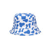 A blue and white bucket hat featuring a cow print pattern, with a branded logo on the side.