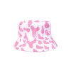 A pink and white bucket hat featuring a cow print design, with a simple logo on it.