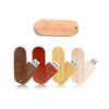 A collection of wooden flash drives in various shades, featuring a carved logo on one drive.