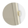 A light beige notebook with a textured cover and a strap closure. It features a logo on the cover.