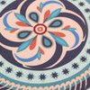 A round trivet featuring a floral design in turquoise, pink, and navy blue, with decorative patterns.