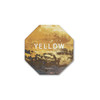 An octagonal frosted metal coaster in yellow with textured patterns and a logo.